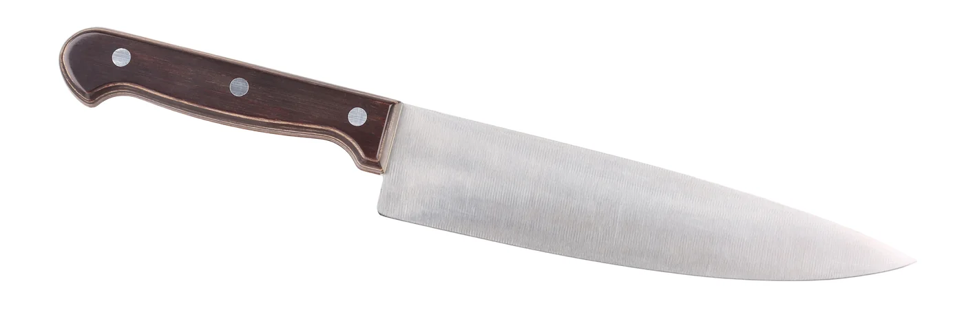 A chef's knife photographed on a plain white surface.