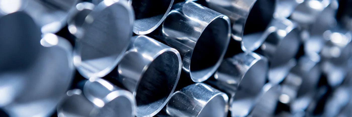 A stack of polished stainless steel tubes, seen end-on.