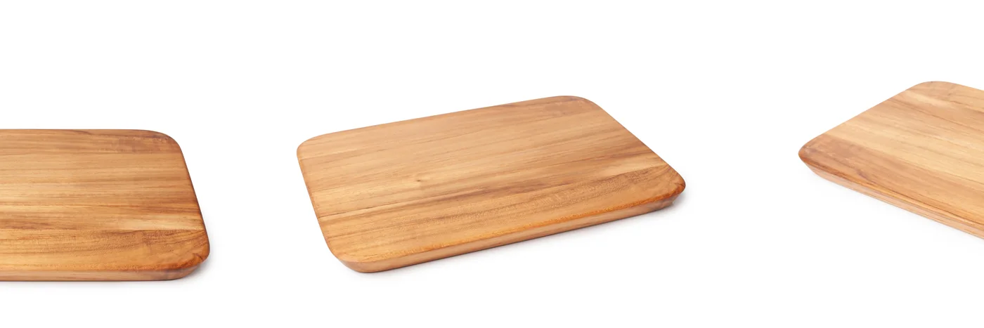 Three plain wooden chopping boards of different sizes on a white background.