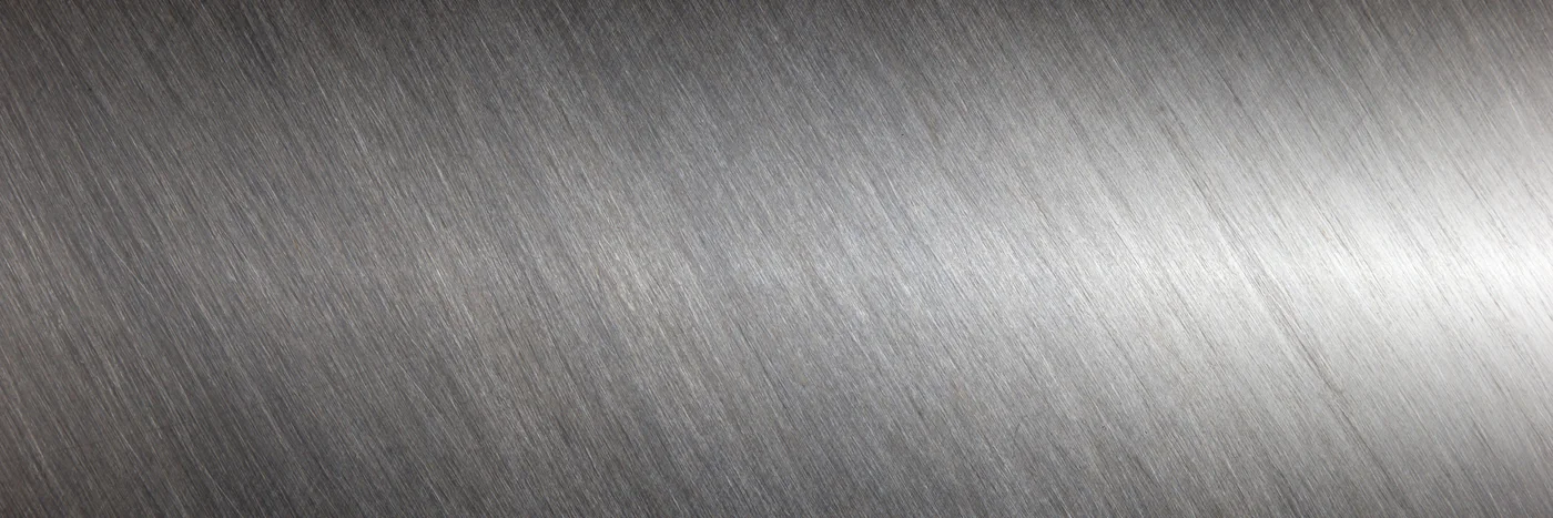 Close-up of a brushed stainless steel surface.